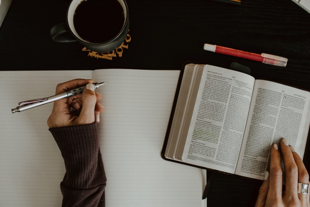 Woman Journaling With Bible - 5 Ways To Fight For Breakthrough From God