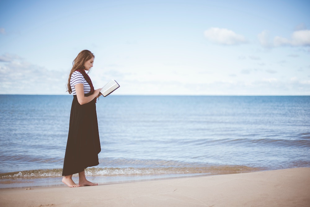 Woman Reading Bible At Beach - How To Stand In Faith That Nothing Is Impossible With God