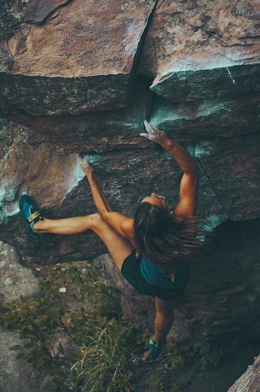 Fearless Woman Climbing a Rock - Being Fearless Is Your Biblical Right