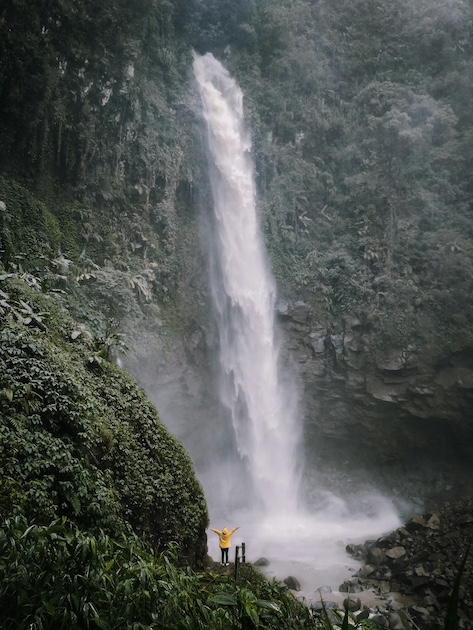 A person with arms raised before a powerful waterfall, symbolizing excitement about leaning into God for the continue healing journey and unfolding of identity and purpose. 
